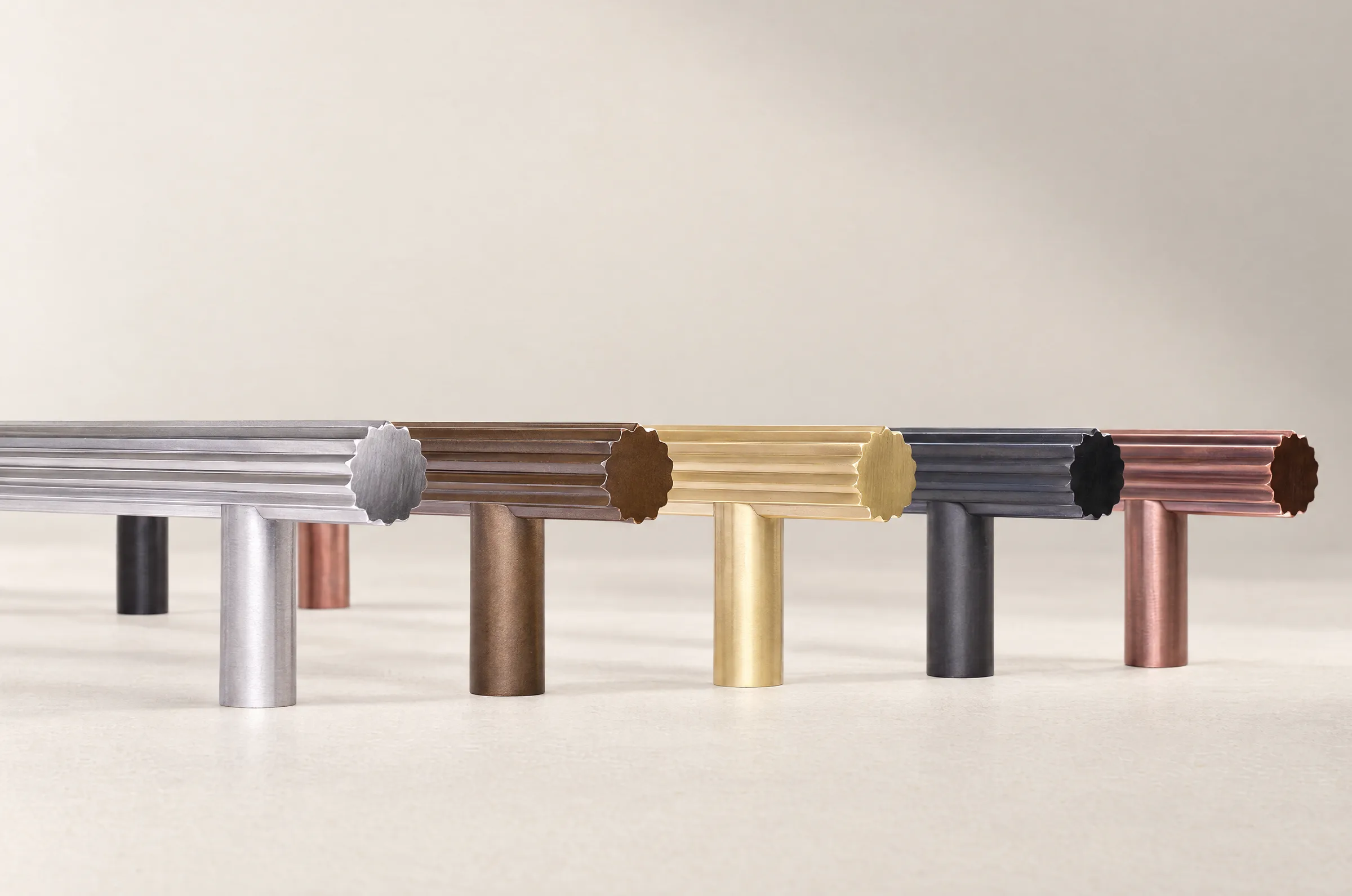 Kita pull handles in the five finishes, standing in a row